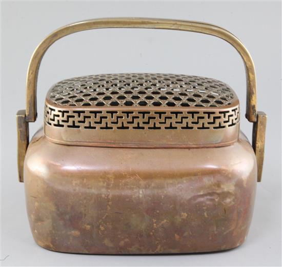 A large Chinese copper alloy hand warmer, 17th / 18th century, width 27cm
